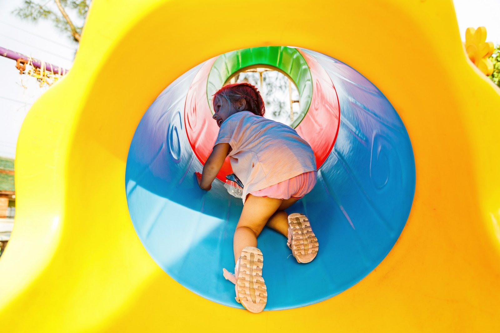 Child playing on indoor playground equipment at Kids Hideout Fort Lauderdale