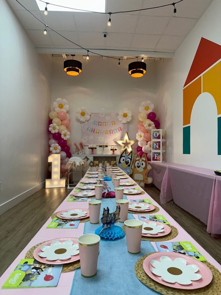 Bluey and Daisies first birthday party theme with blue balloons and daisy flower decorations at Kids Hideout Fort Lauderdale