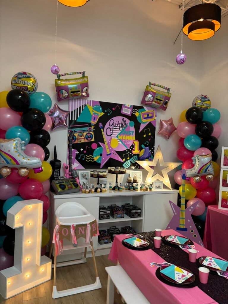Girls Just Want to Turn ONE 80s retro first birthday party theme with neon decorations at Kids Hideout Fort Lauderdale
