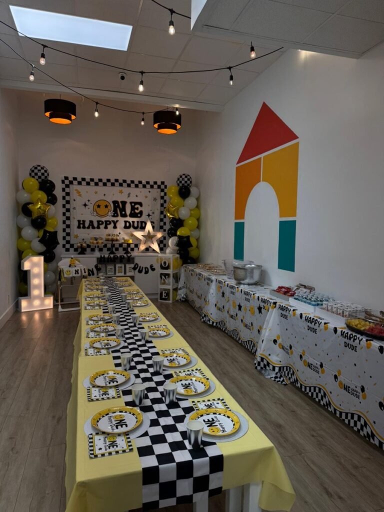 ONE Happy Dude birthday party wide view showing full retro party setup at Kids Hideout