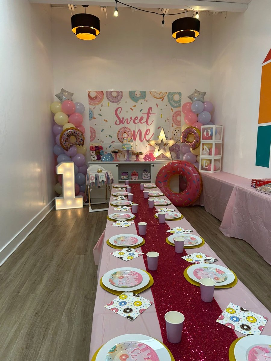 Sweet One first birthday party decorations with pastel colors and sweets theme