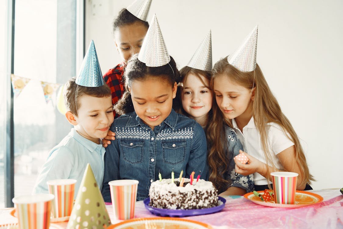Child with birthday cake and candles at a first birthday celebration