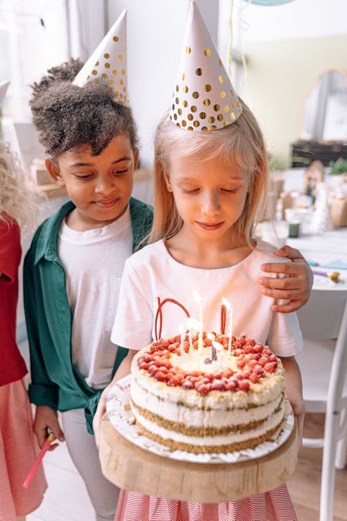 Happy children wearing party hats at a Kids Hideout birthday celebration in Fort Lauderdale
