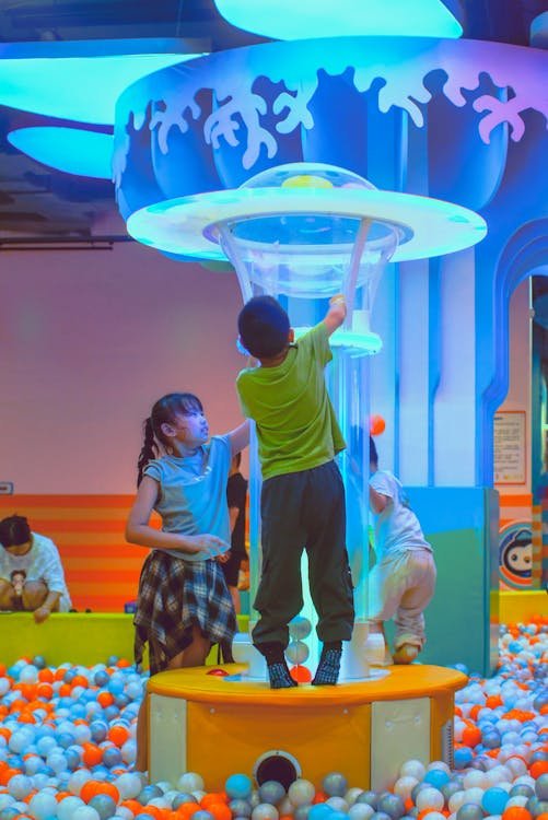 Kids playing in a colorful indoor playground ball pit in Fort Lauderdale